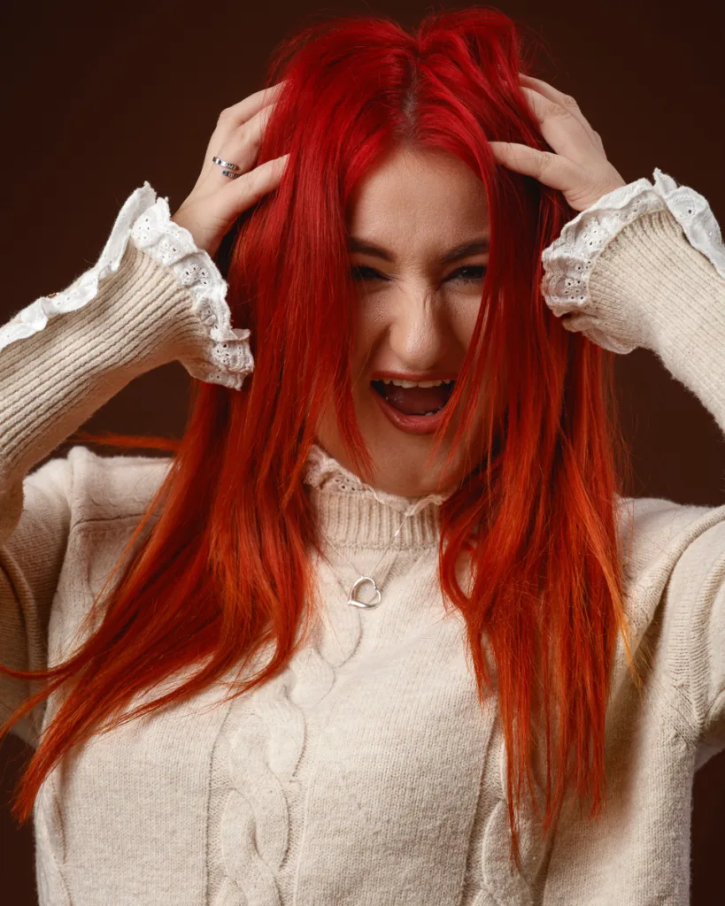 Woman with red hair expressing frustration