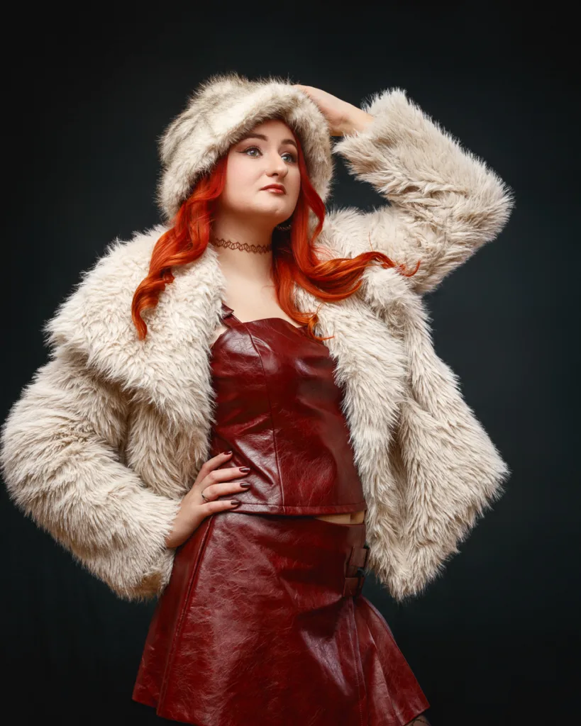 Fashion model in red leather and faux fur coat