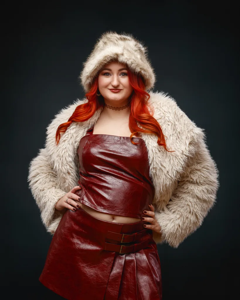 Woman wearing red leather outfit and faux fur coat