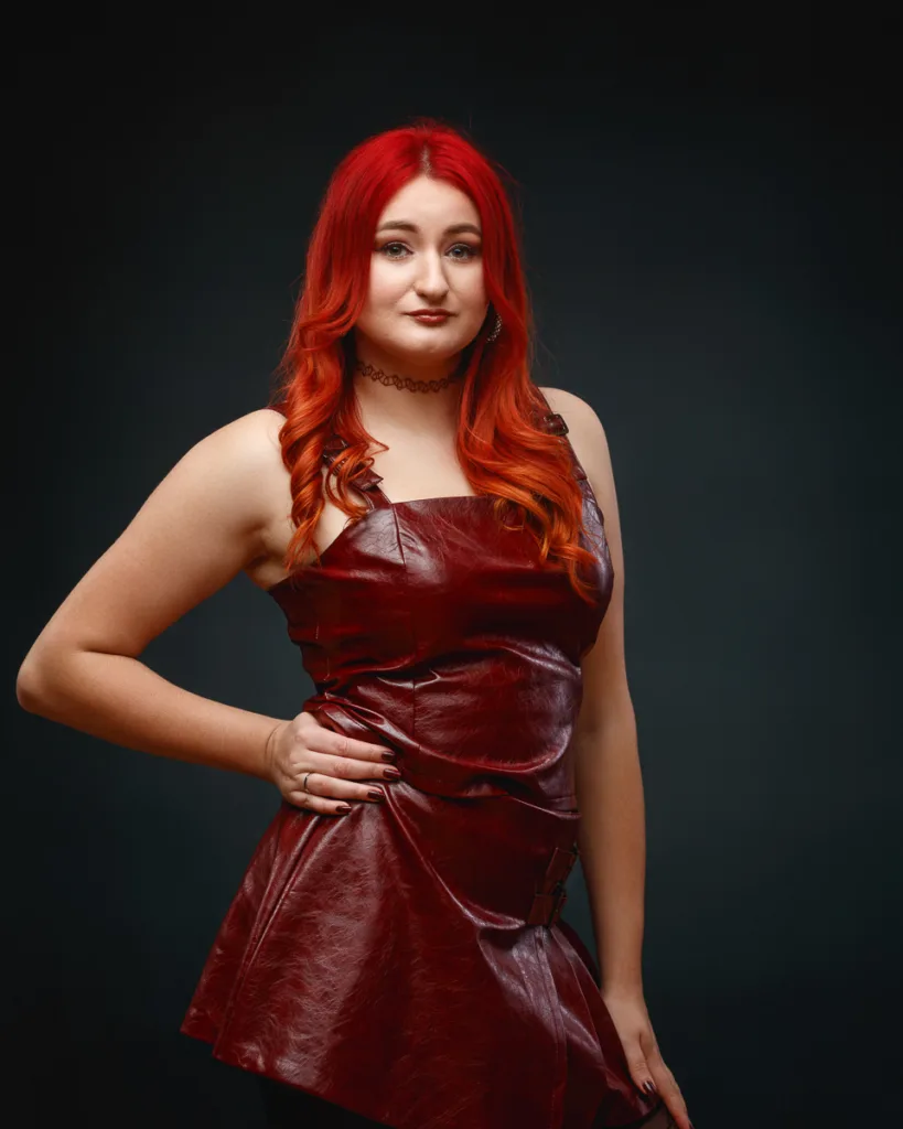 Woman with red hair in red leather dress