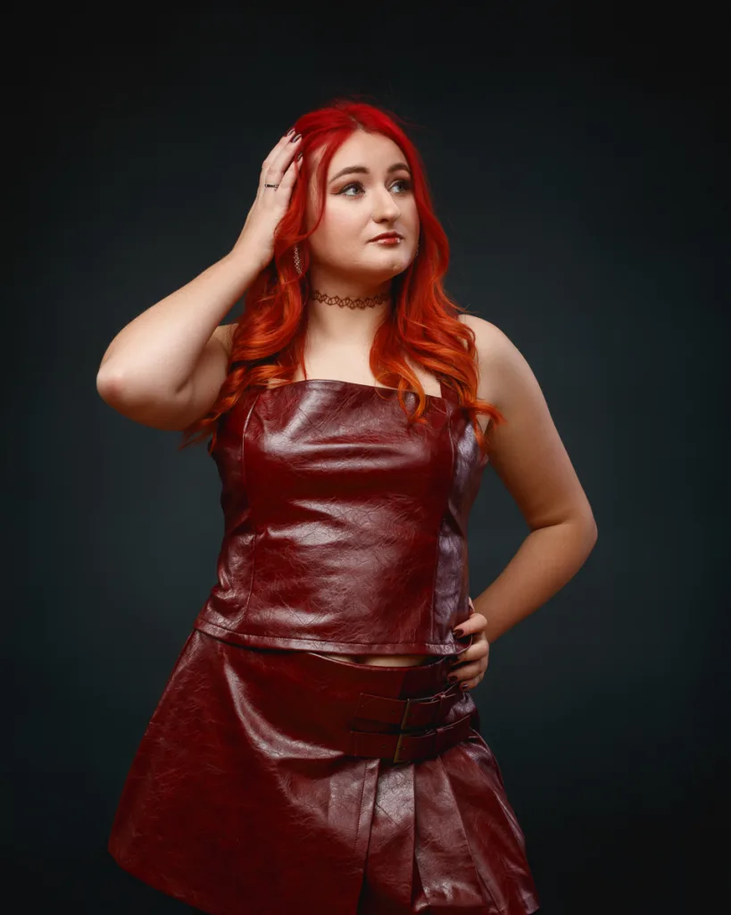 Woman with red hair in red leather outfit