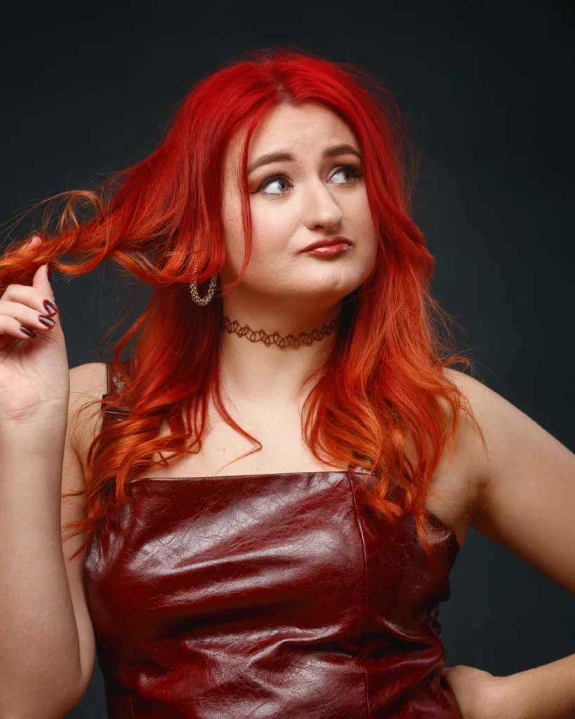 Woman with red hair wearing red leather dress