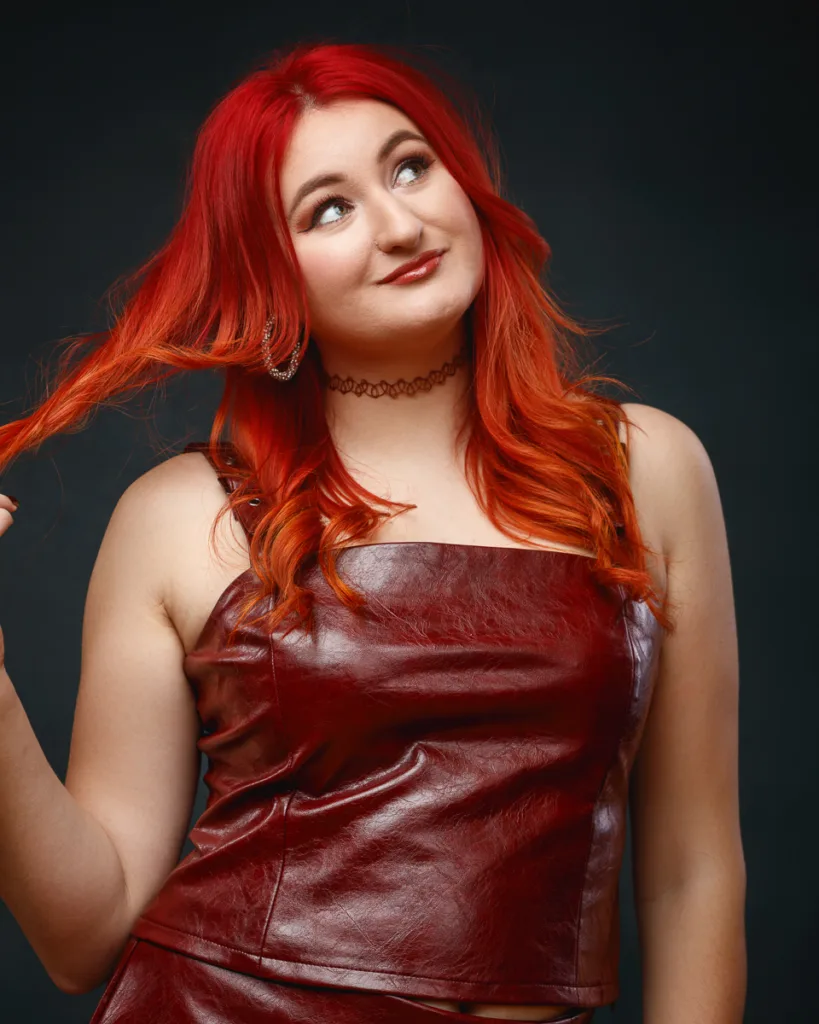 Woman with red hair wearing red leather top