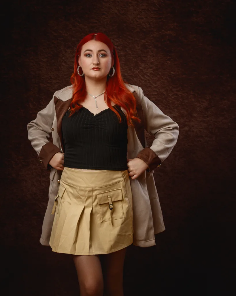 Person with red hair posing confidently indoors