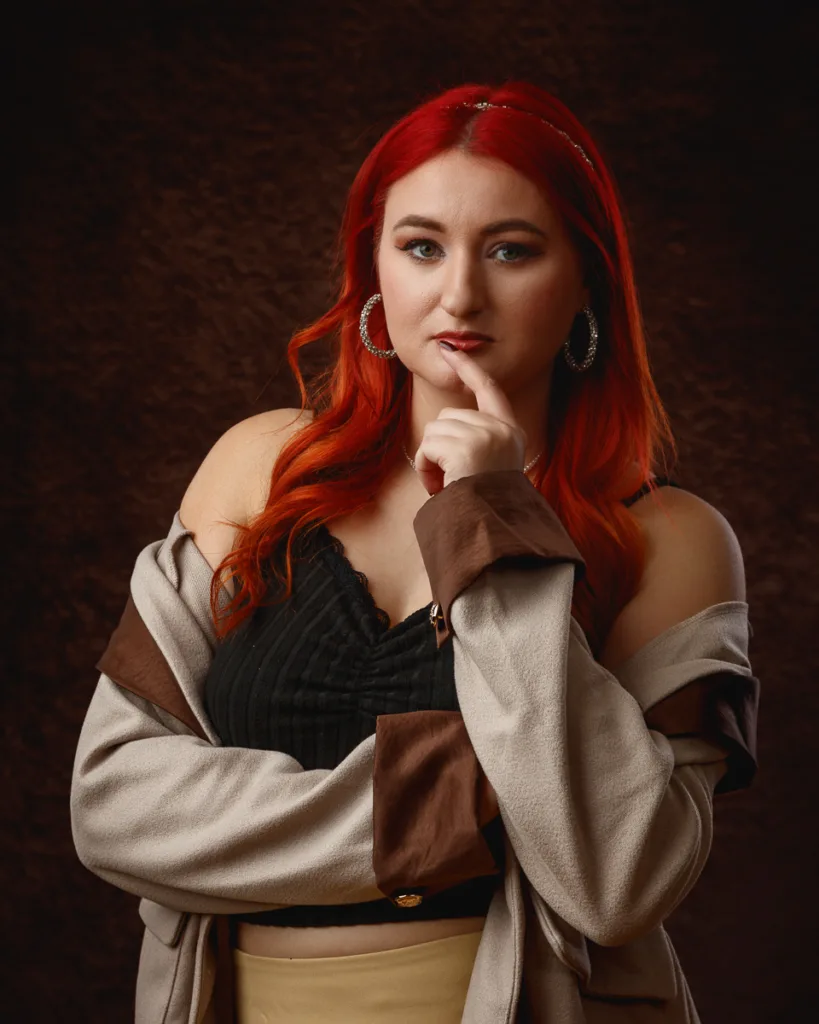 Woman with red hair posing thoughtfully indoors