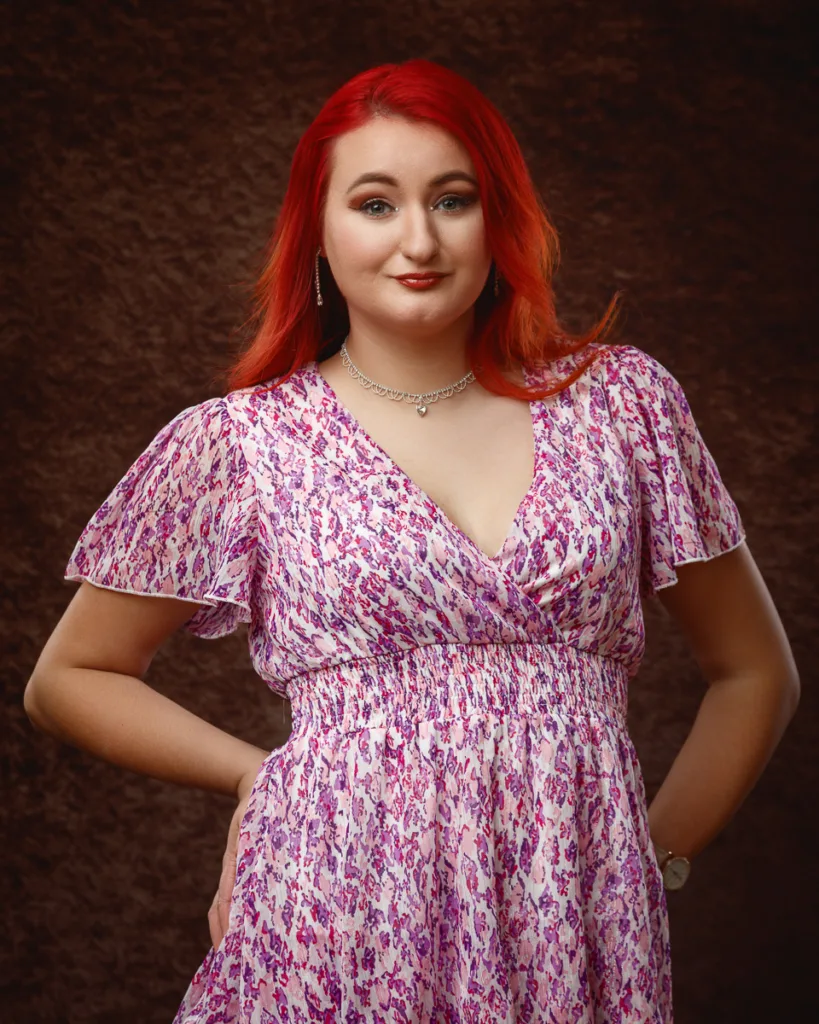 Person posing in pink floral dress