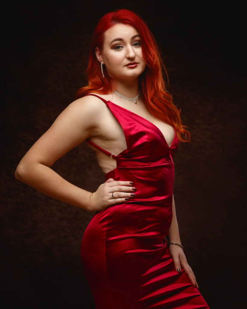 Woman posing in elegant red evening dress