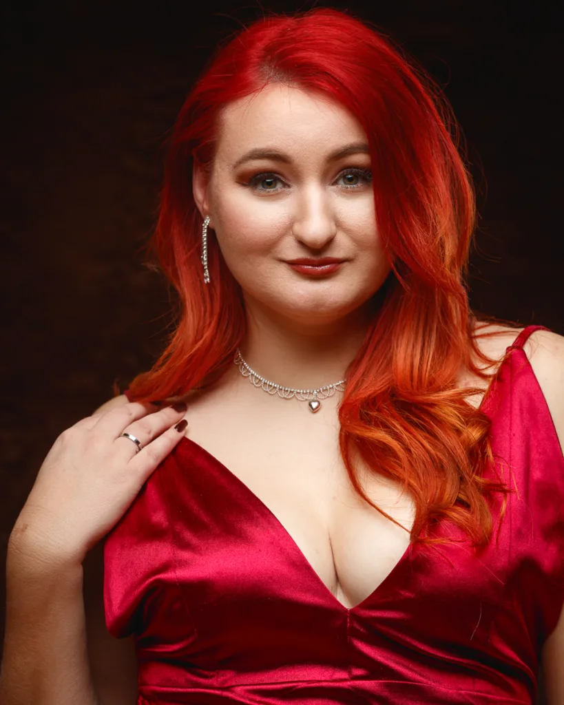 Woman with red hair in elegant red dress