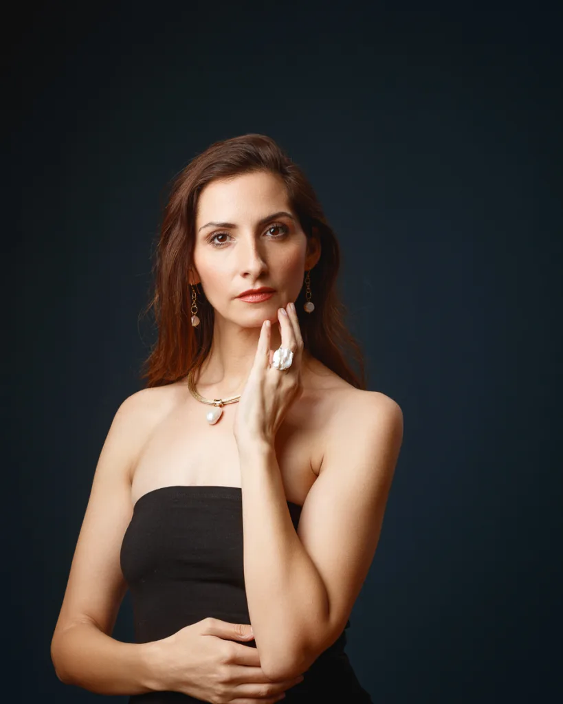 Woman posing with jewellery, dark background