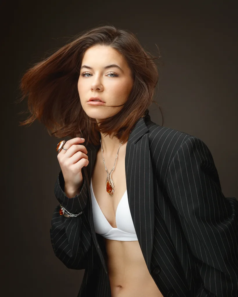 Woman in blazer and jewellery, professional portrait