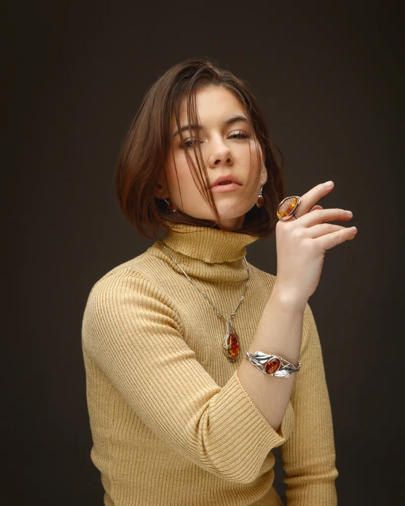 Woman wearing amber jewellery, showcasing elegance.