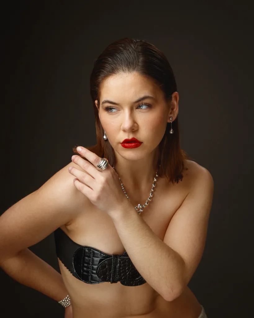 Woman with jewellery and red lipstick posing