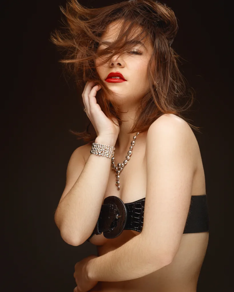 Woman with red lipstick and jewellery.