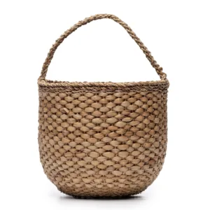 Woven seagrass basket with handles on white background