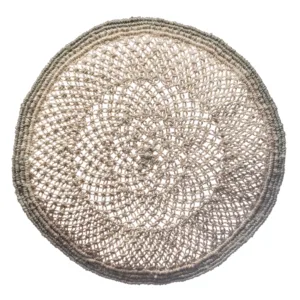 Round woven seagrass placemat with natural tan coloring